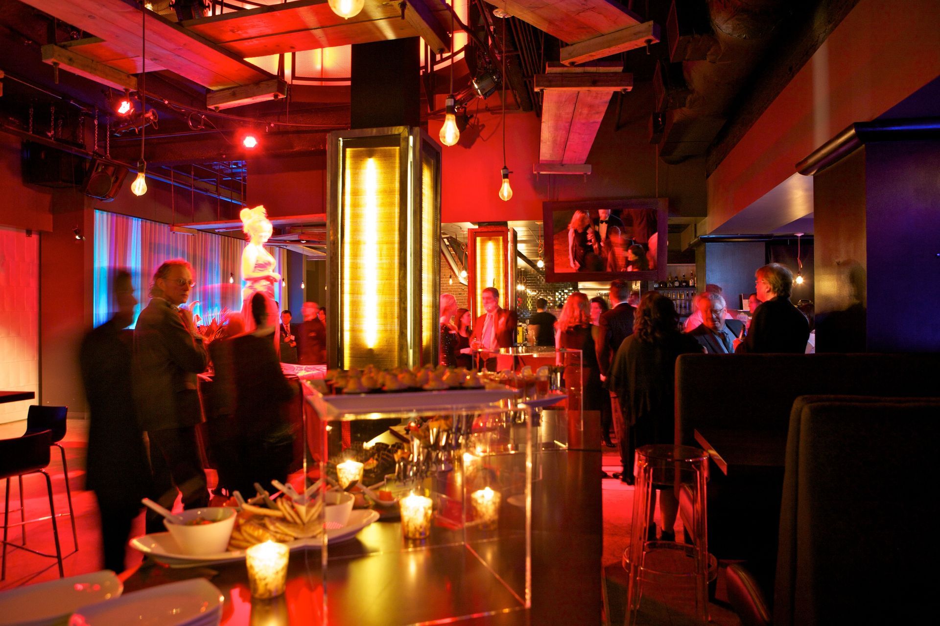A group of people are standing around a table in a restaurant.
