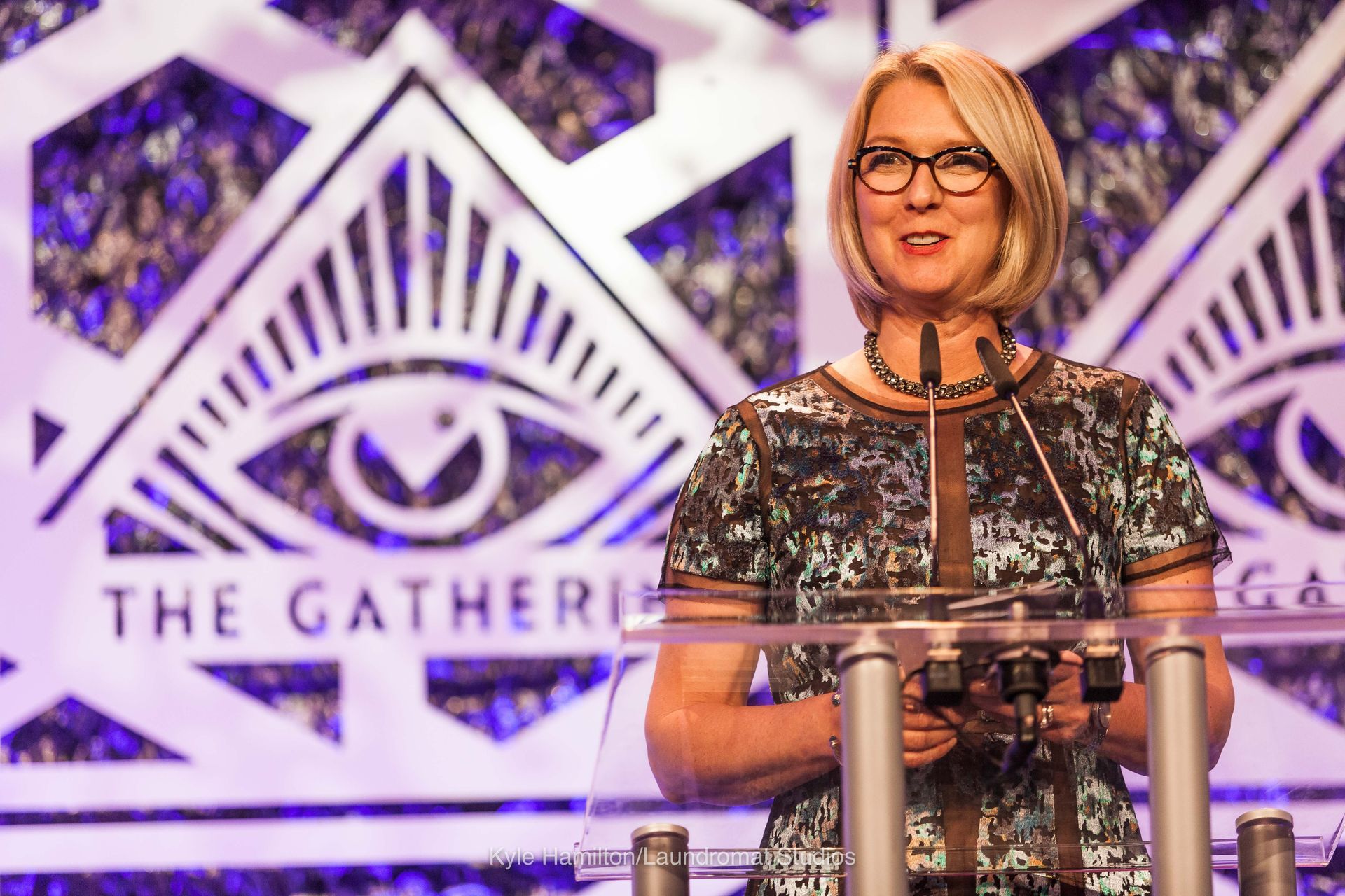 A woman is standing at a podium giving a speech.