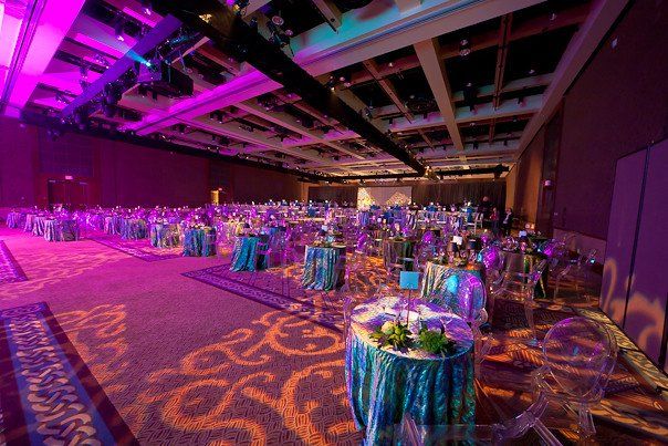 A large room with tables and chairs set up for a party.
