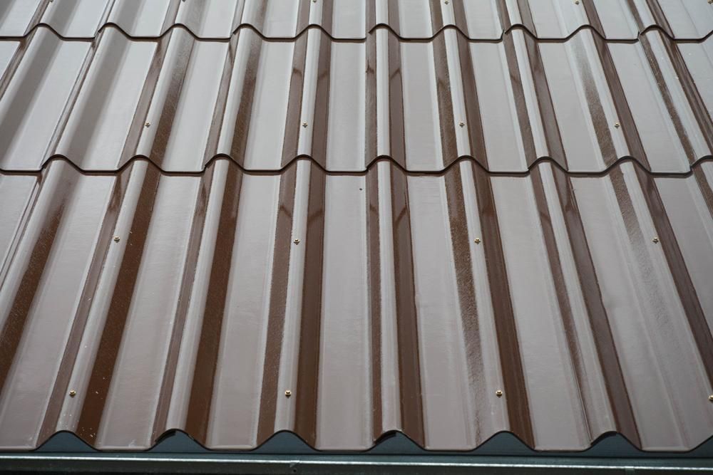 A Close Up Of A Brown Corrugated Metal Roof — APEX Painting & Maintenance In Flinders, NSW