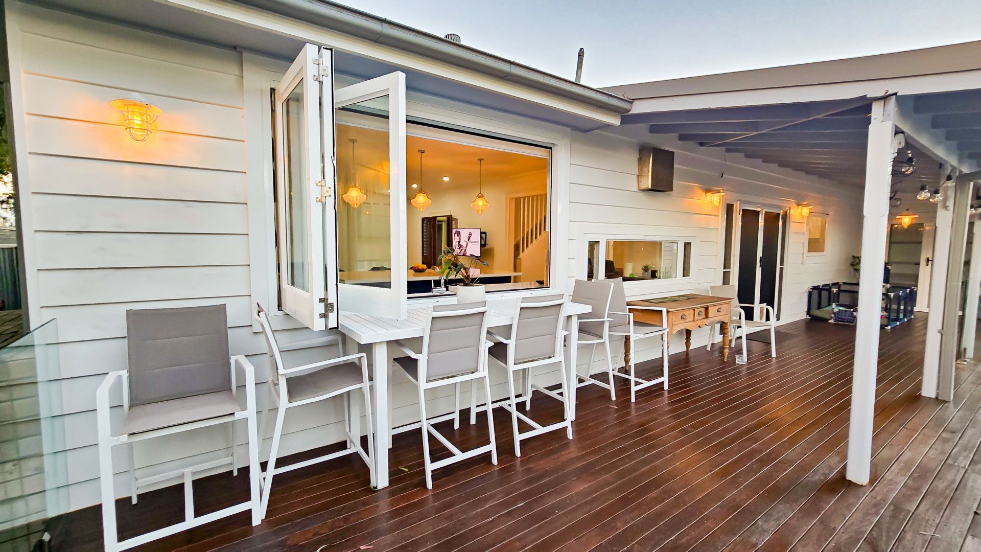 A White Garage Door Is Sitting On The Side Of A House — APEX Painting & Maintenance In Primbee, NSW