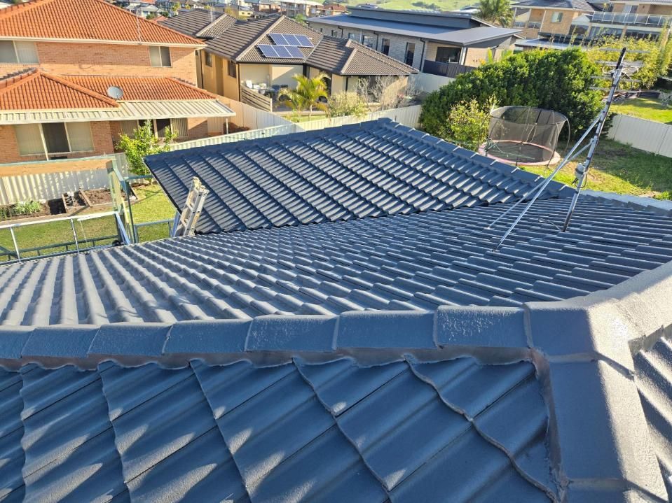 A Roof With A Lot Of Tiles On It In A Residential Area — APEX Painting & Maintenance In Primbee, NSW