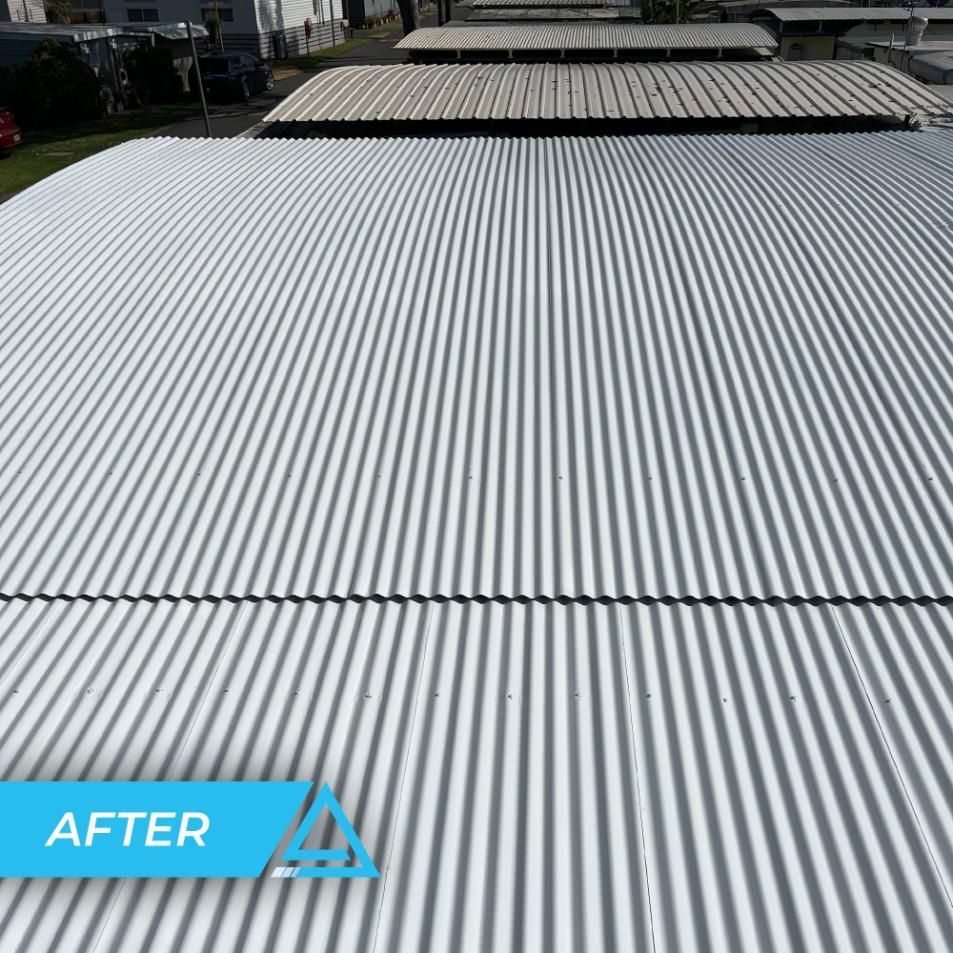 A Picture Of A White Corrugated Metal Roof After Being Painted — APEX Painting & Maintenance In Primbee, NSW
