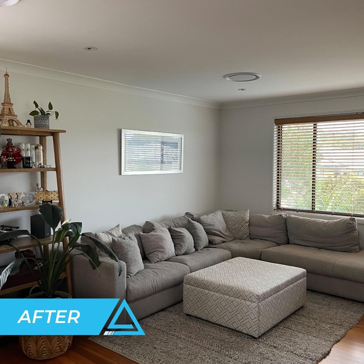 A Living Room With A Couch And Ottoman — APEX Painting & Bricklaying In Cordeaux Heights, NSW