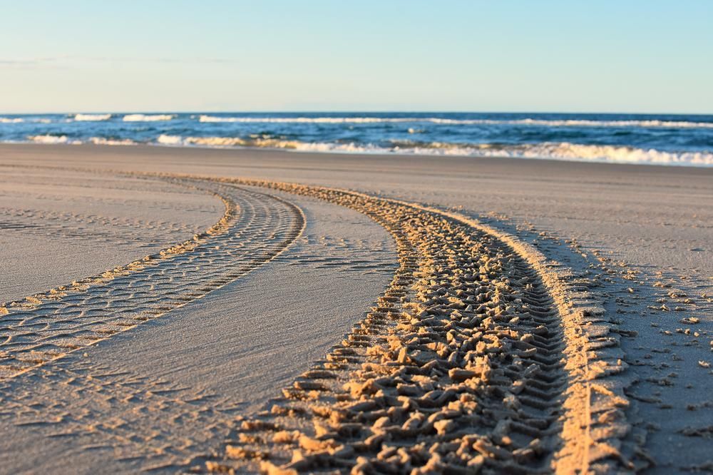There Are Tire Tracks In The Sand On The Beach — APEX Painting & Maintenance In Flinders, NSW