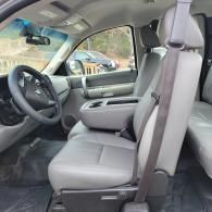 Front passenger area of a gray car interior with seats, dashboard, and steering wheel visible
