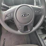 Kia steering wheel and driver’s side dashboard inside a car interior