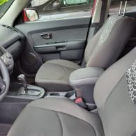 Car interior with gray cloth front seats and center console in view