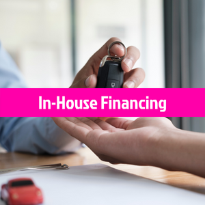 Hands exchanging car keys over paperwork with pink banner reading “In-House Financing”