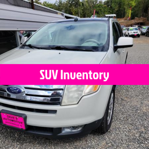 White Ford SUV in dealership lot with pink