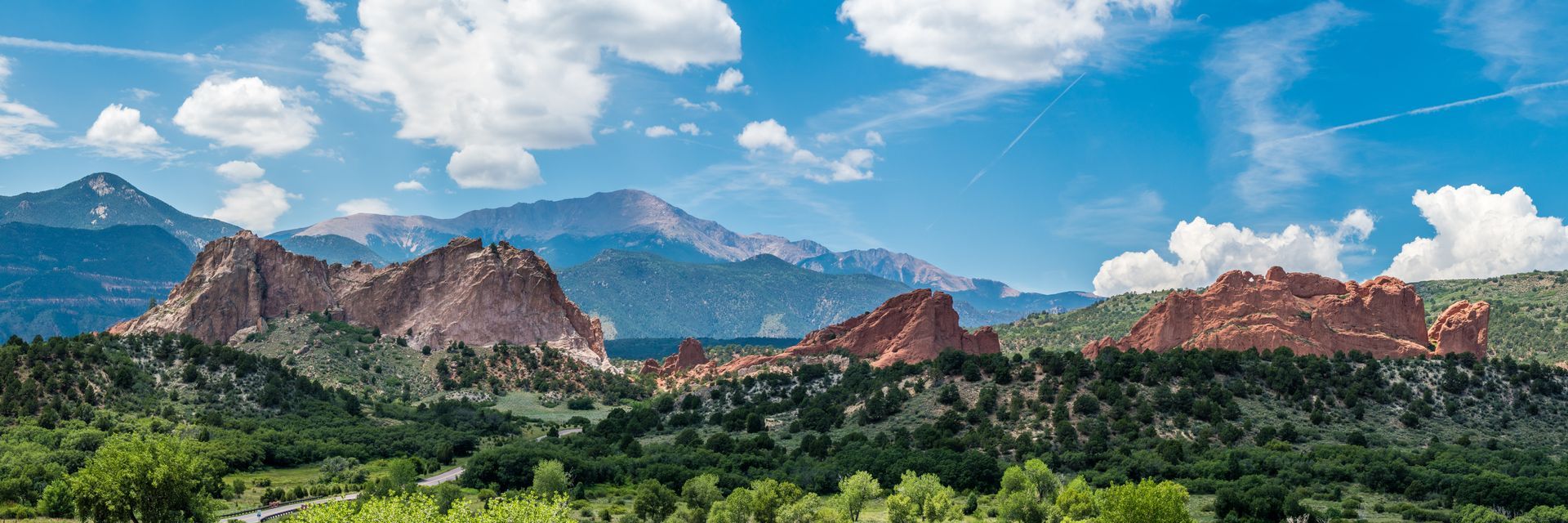 There are mountains in the background and trees in the foreground.