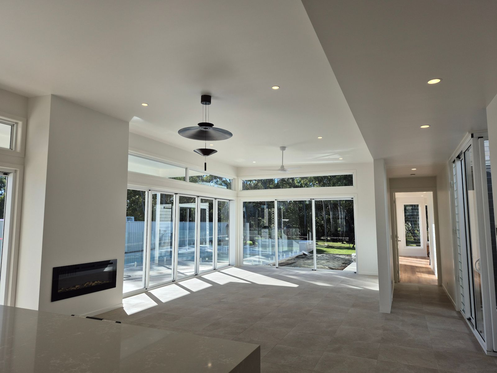 Bright Modern Empty Living Room With Large Glass Doors — Pristine Cleaning Bundaberg In Kalkie, QLD