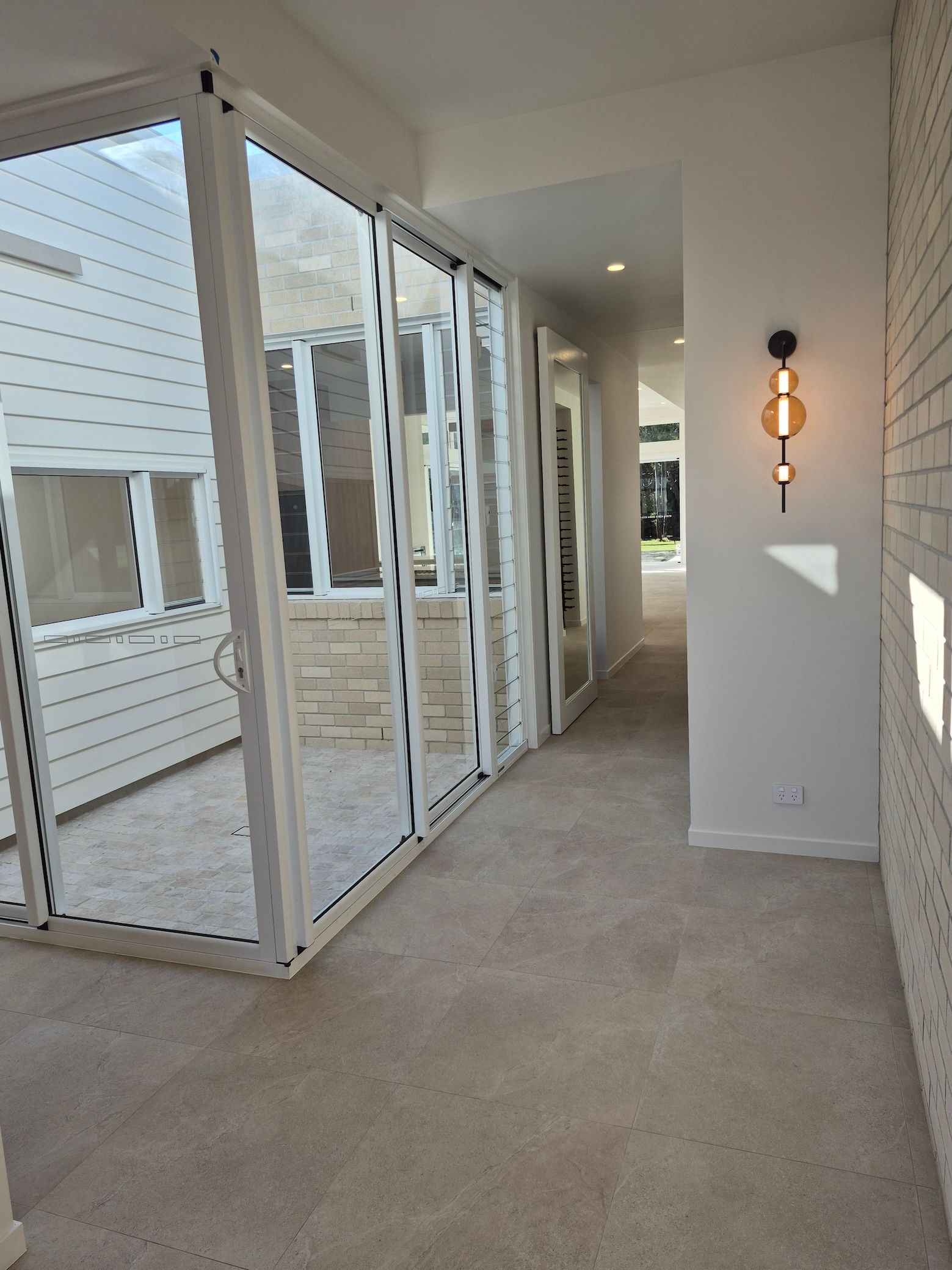 A Hallway with Glass Doors to A Patio — Pristine Cleaning Bundaberg In Kalkie, QLD