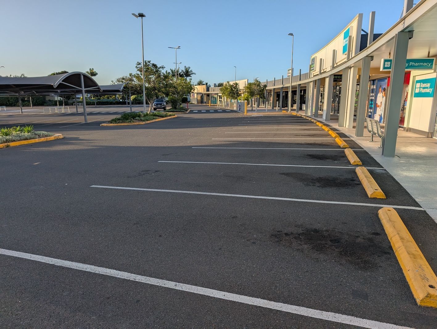 An Empty Parking Lot in Front of A Shopping Center — Pristine Cleaning Bundaberg In Kalkie, QLD