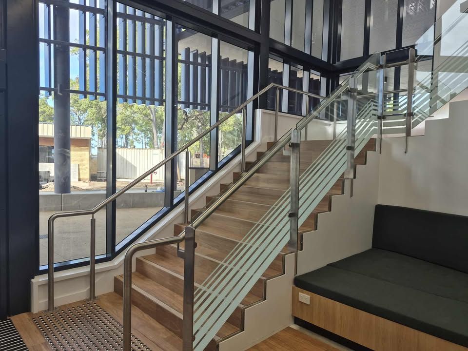 Staircase With Wood Steps, Glass Railing, and Large Windows in a Bright Interior Room — Pristine Cleaning Bundaberg In Kalkie, QLD