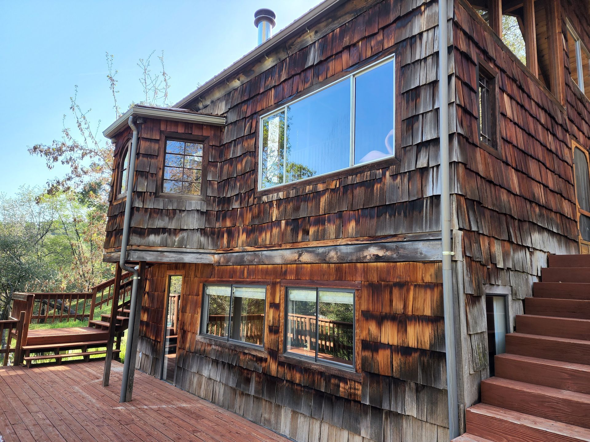 A large wooden house with stairs leading up to it