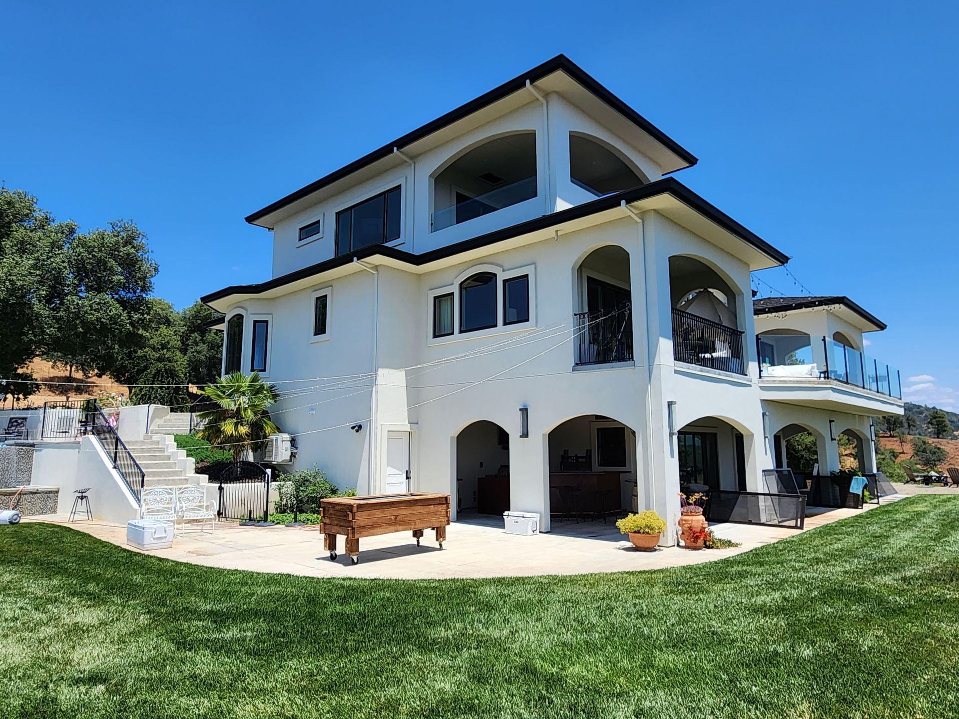 A large white house with a pool table in front of it.