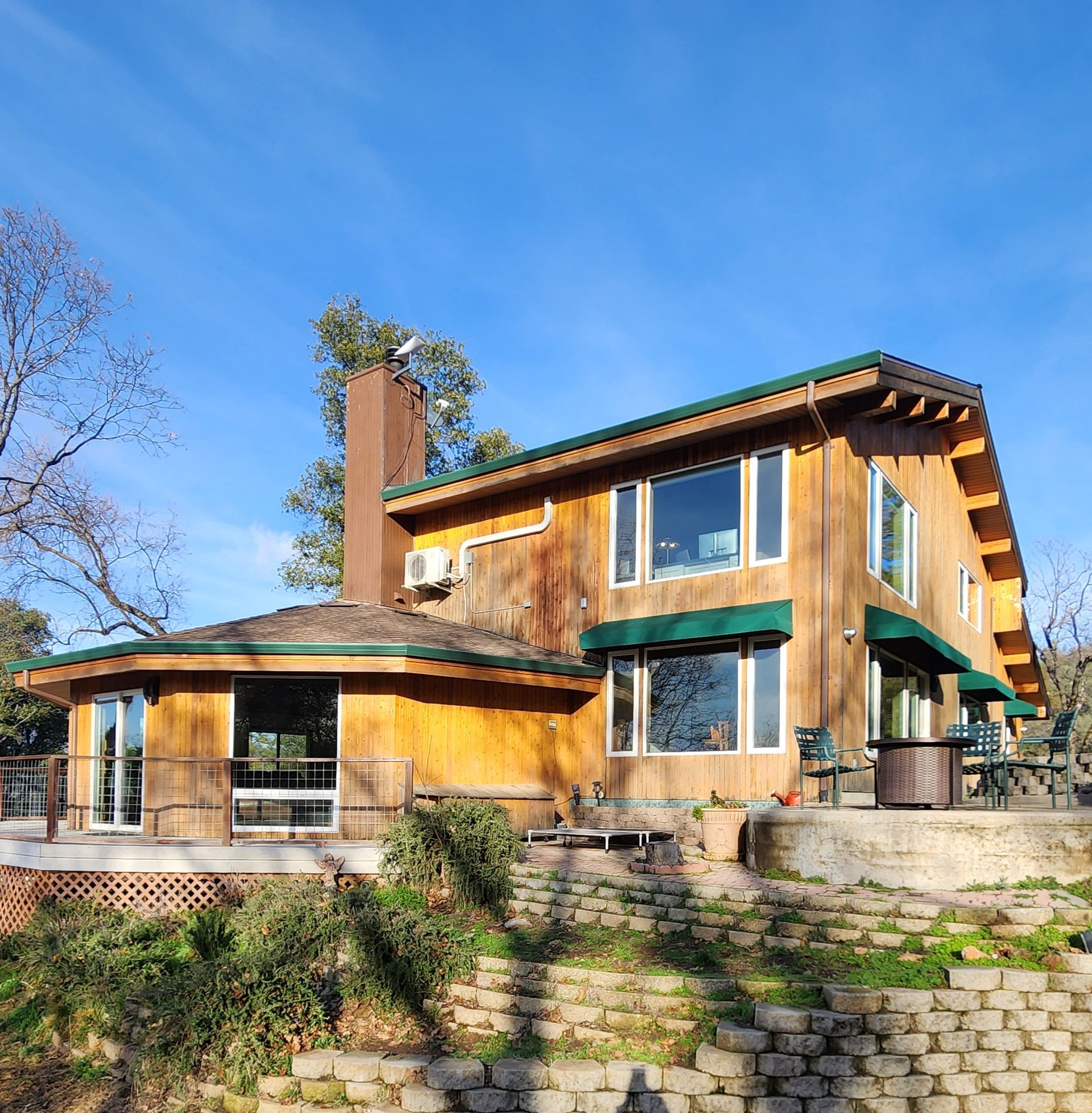 A large house with a lot of windows and a green awning