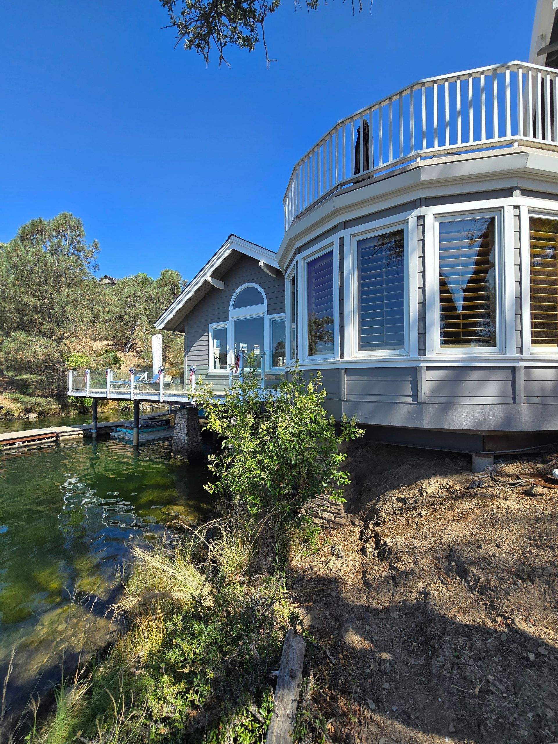A house with a balcony overlooking a body of water