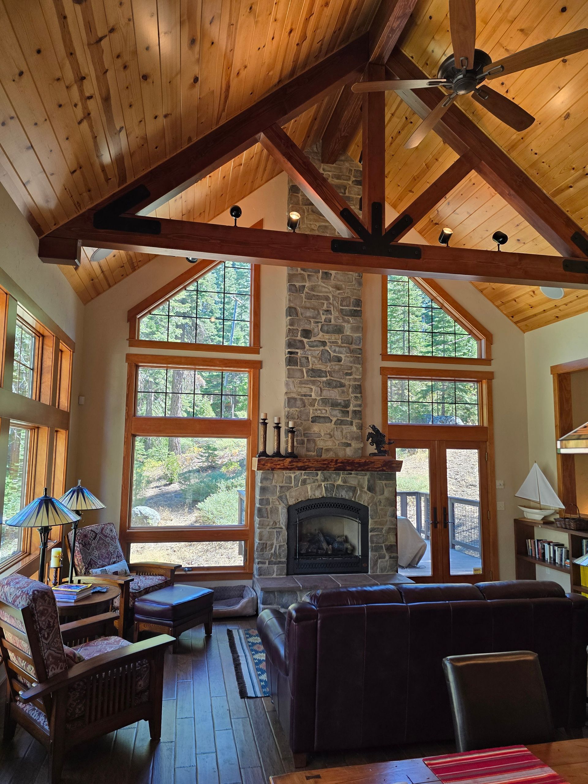 A living room with a fireplace and lots of windows