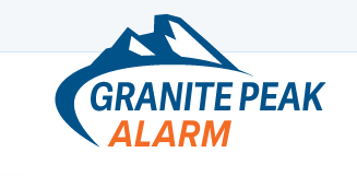 A logo for granite peak alarm with a mountain in the background