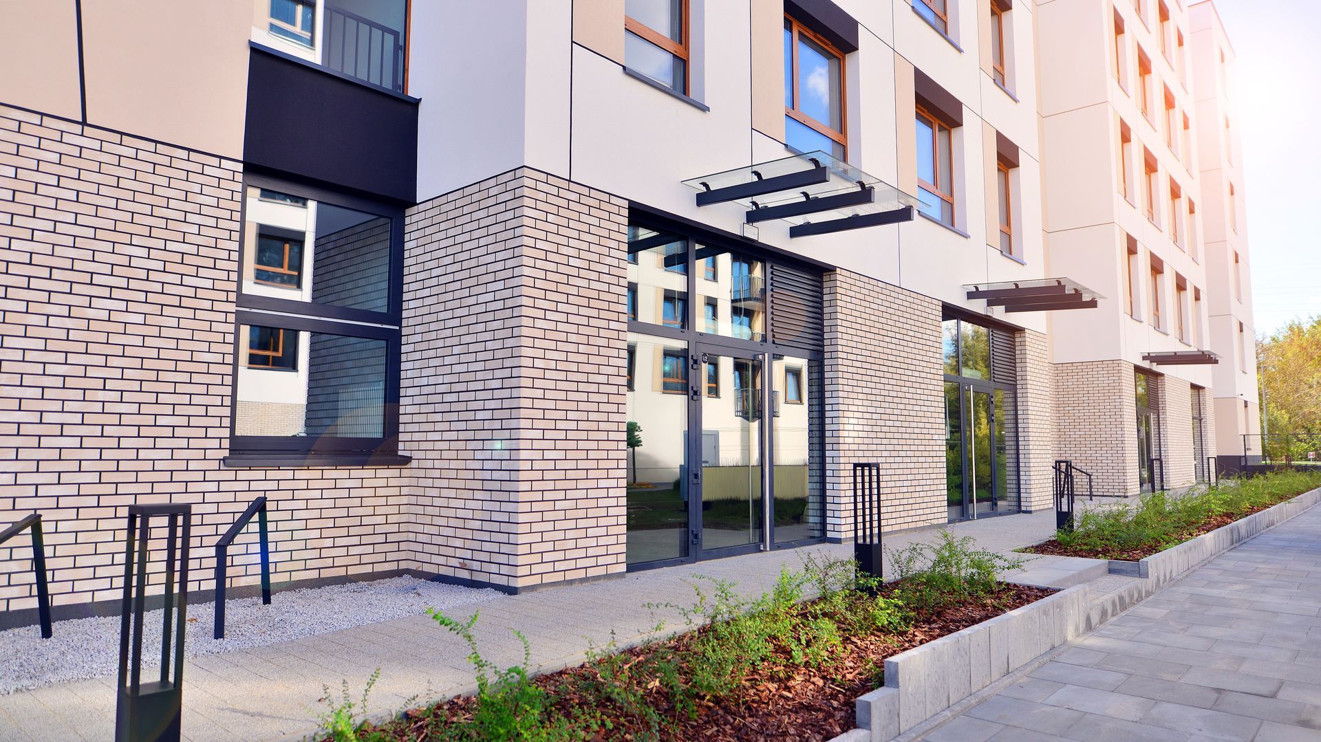 Modern apartment building exterior with unique, textured brick patterns.