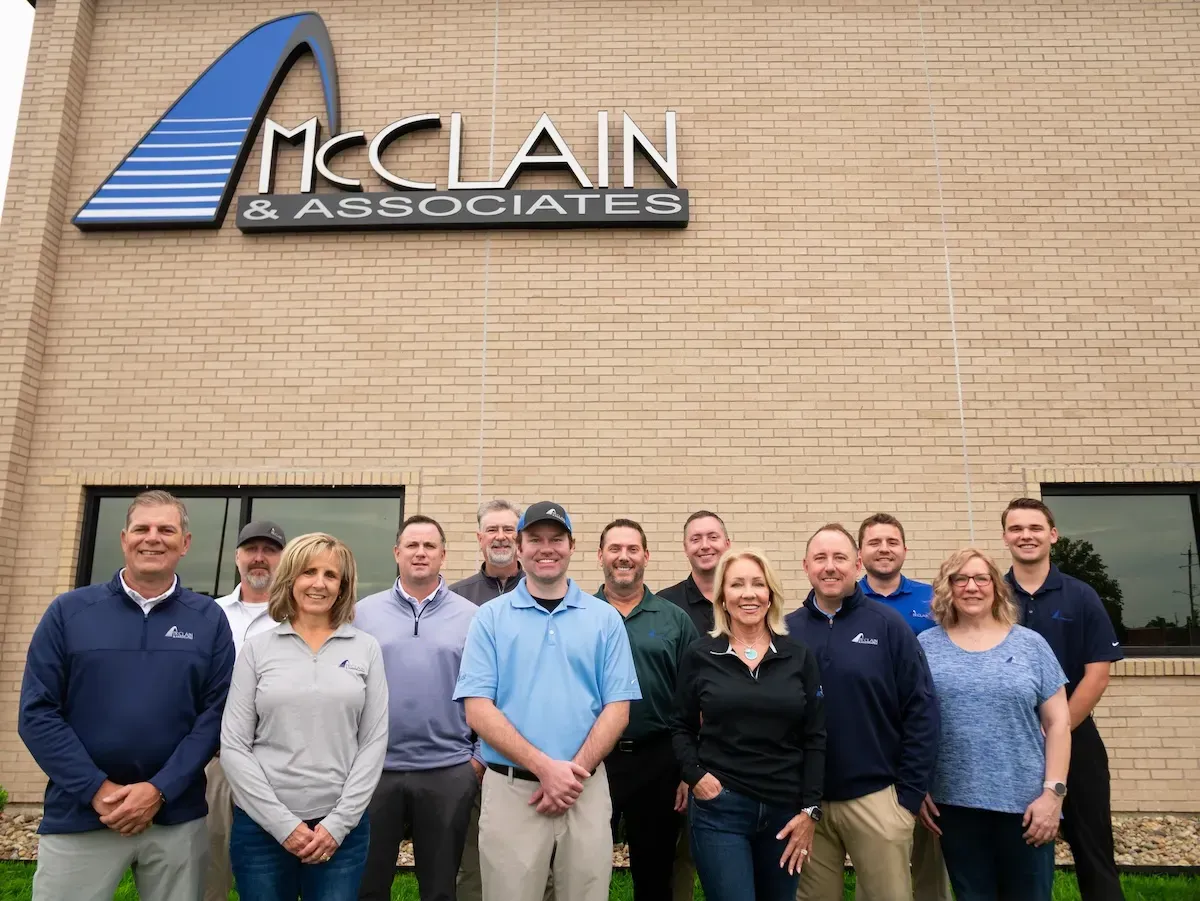 Group of employees standing outside McClain & Associates office building