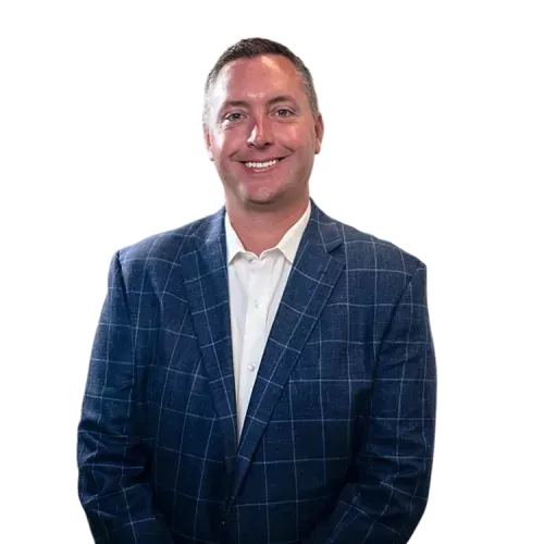 Smiling man in a blue plaid blazer and white shirt against a white background