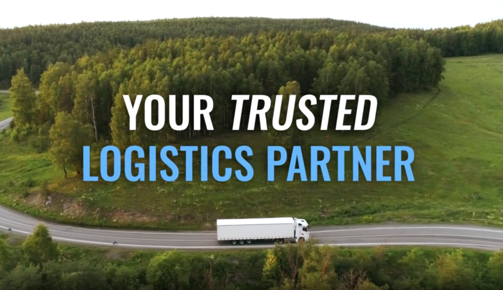 White truck on a highway by a forest with text: “Your trusted logistics partner”