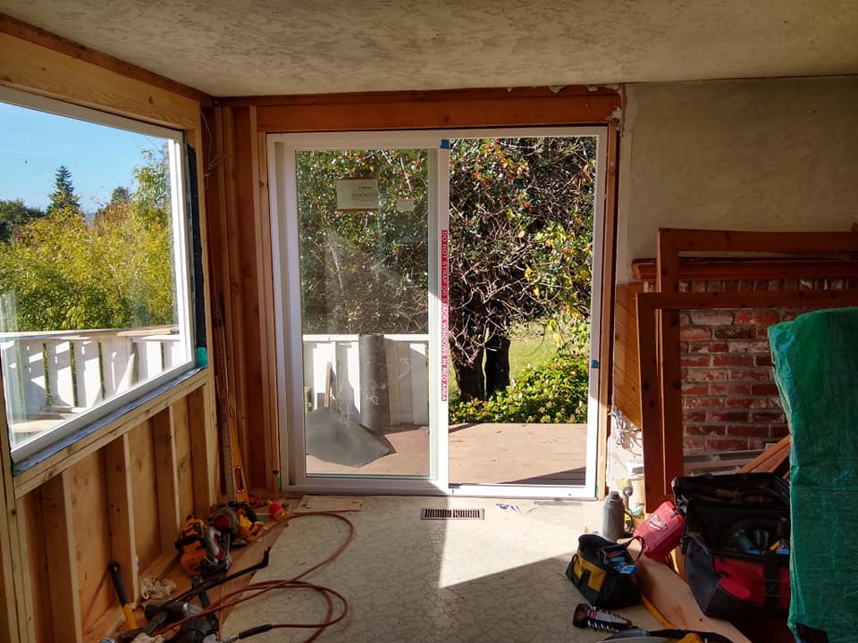 A room with a sliding glass door and a window