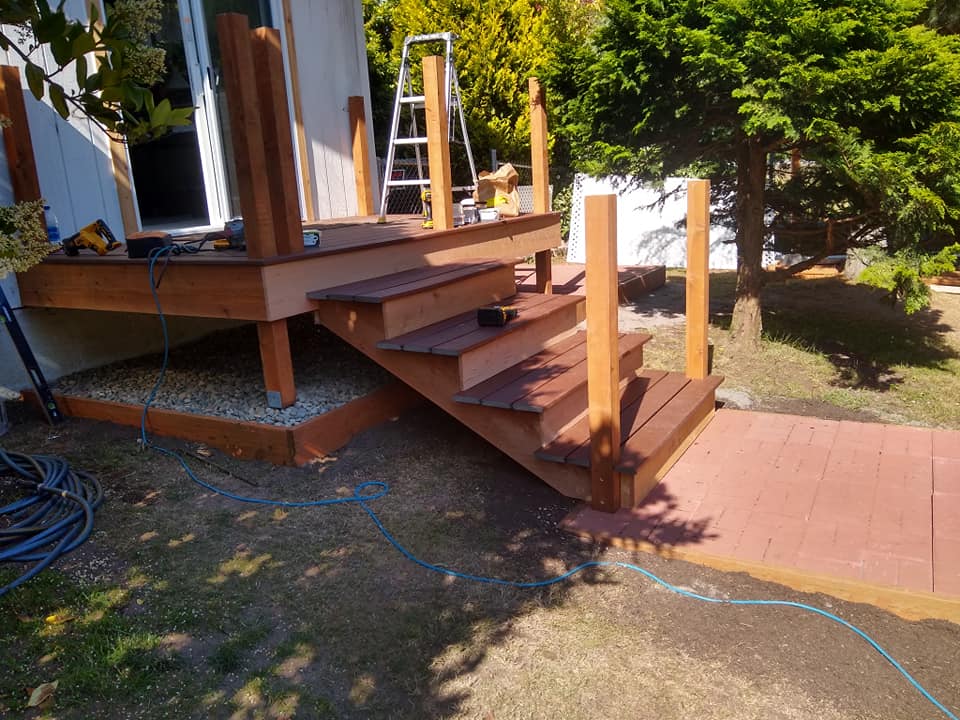 A wooden deck with stairs leading up to it