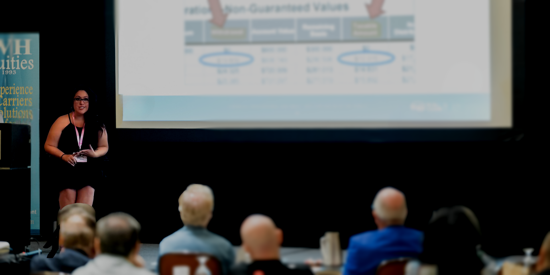 A woman is giving a presentation to a group of people