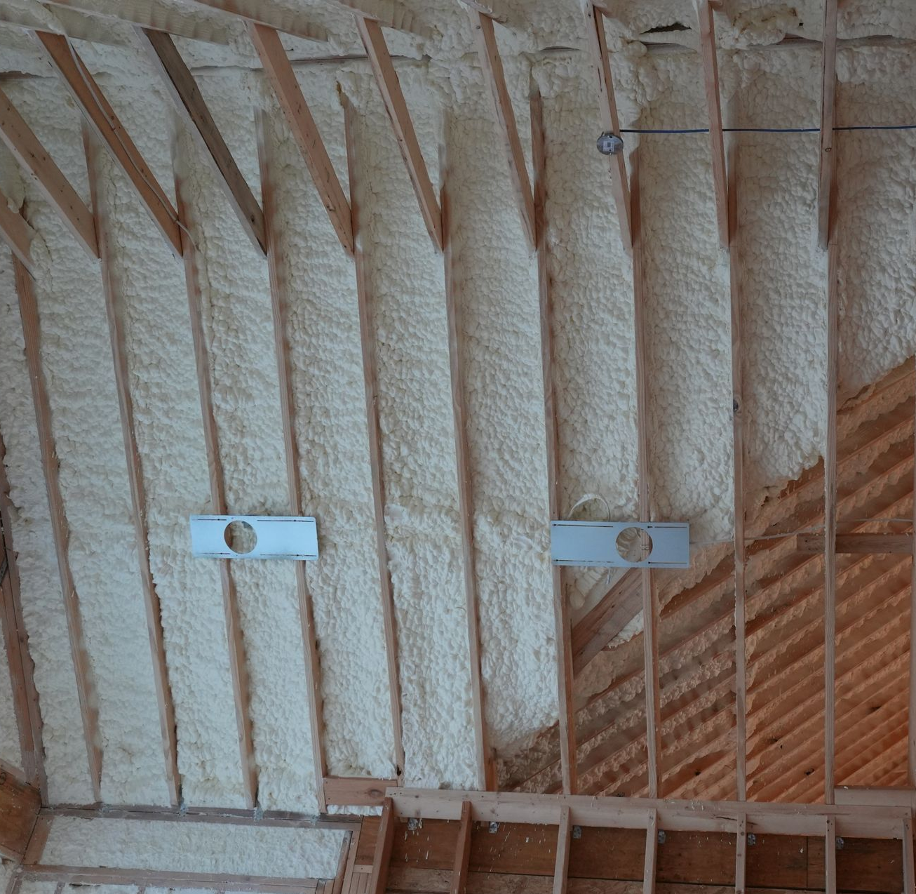An attic with a lot of foam on the ceiling