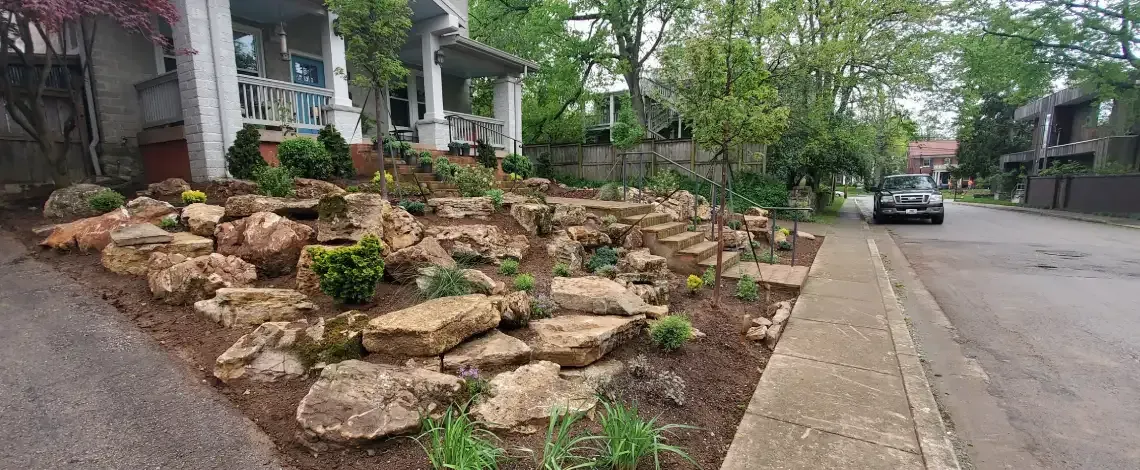 Stone retaining wall adding structure and elevation to a landscaped area in Lexington KY