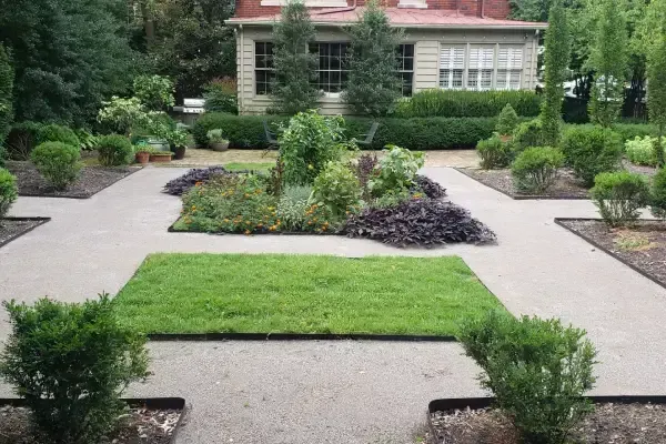 Professionally installed landscape with layered greenery and natural stone accents in Lexington KY