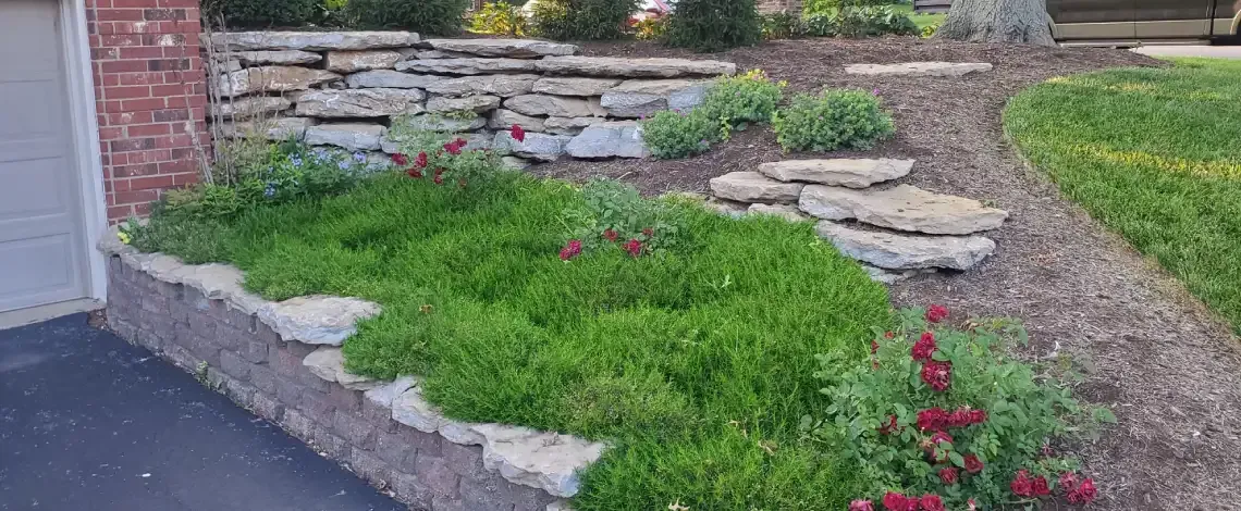 Landscape retaining wall supporting a sloped yard and defined planting area in Lexington KY
