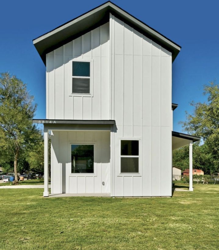 a house with a white garage door and a concrete driveway