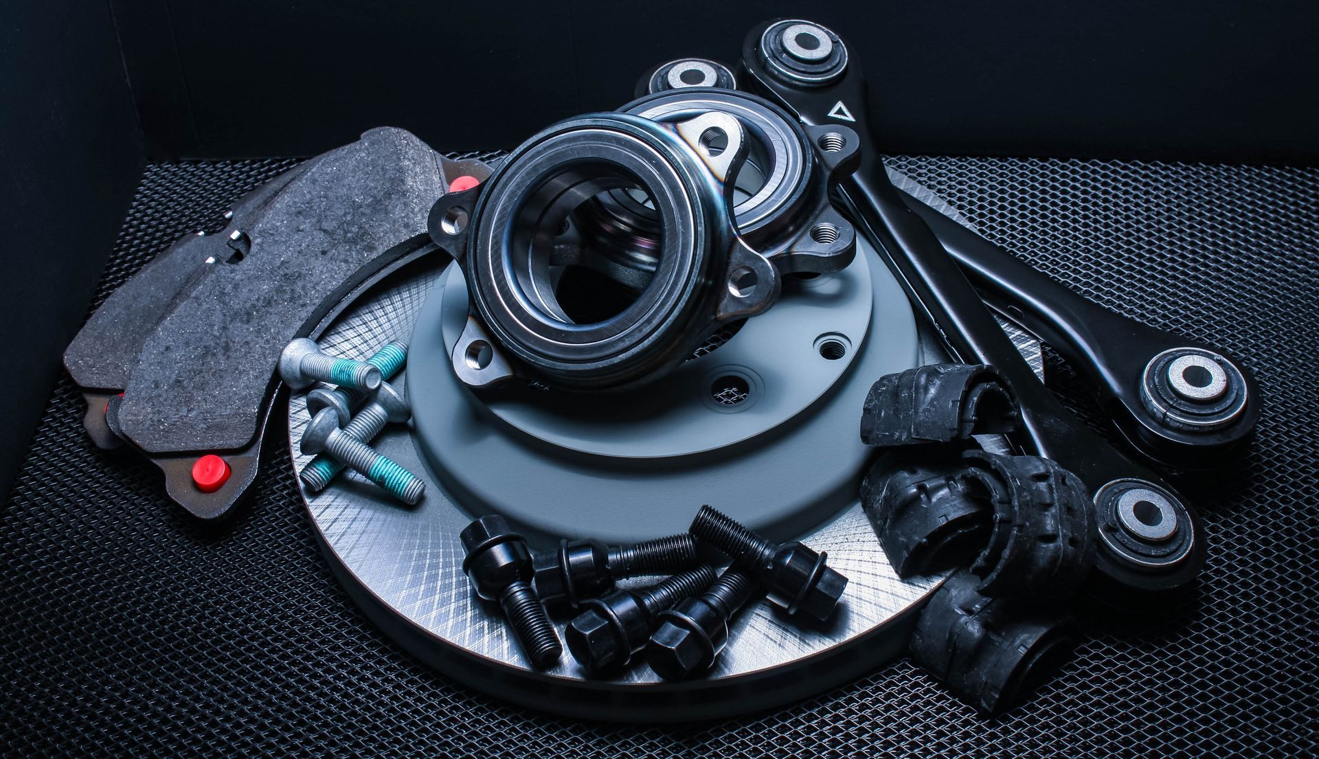A bunch of car parts are sitting on top of each other on a table.
