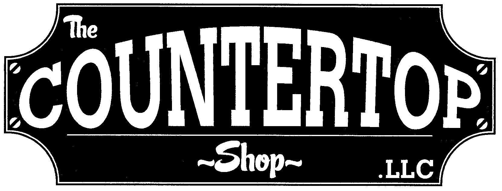 A black and white sign for the A black and white sign for the The Countertop Shop 