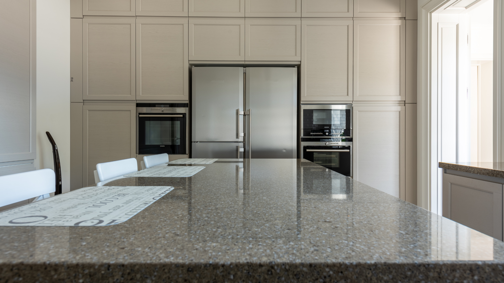 A kitchen with stainless steel appliances and a granite counter top.