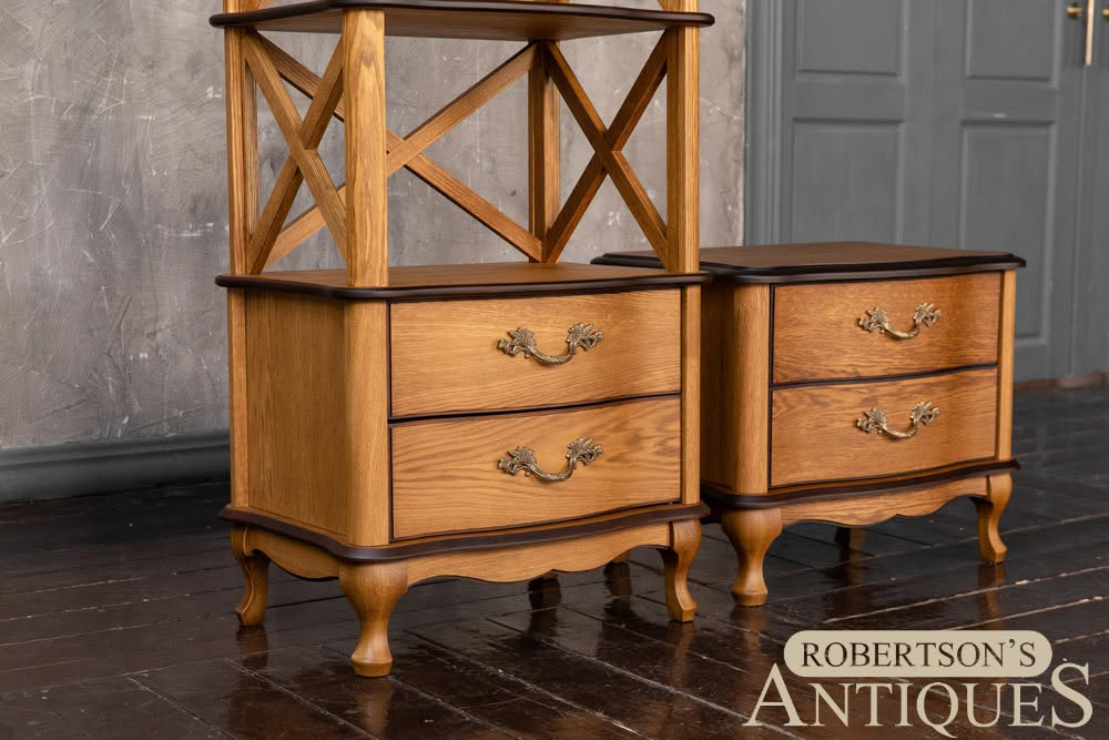 Antique wooden chest of drawers with open shelf top in a room, featuring curved legs and brass pulls