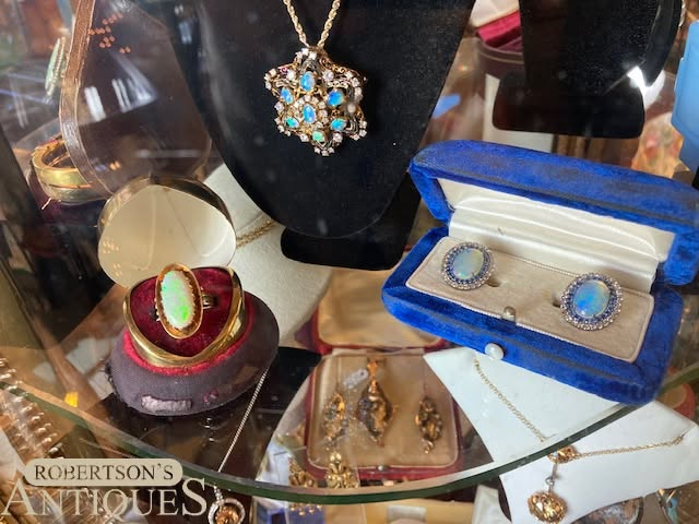 Jewelry display with necklaces, rings, earrings, and gemstone accessories in cases