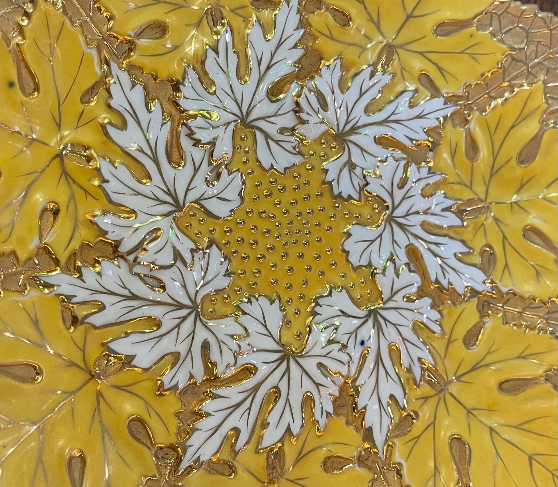 Yellow and white floral patterned fabric with a starburst arrangement of leaves and flowers