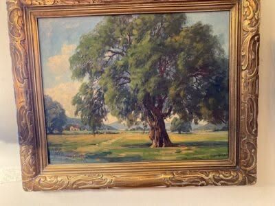 Framed landscape painting of a large tree in a sunlit field under a blue sky