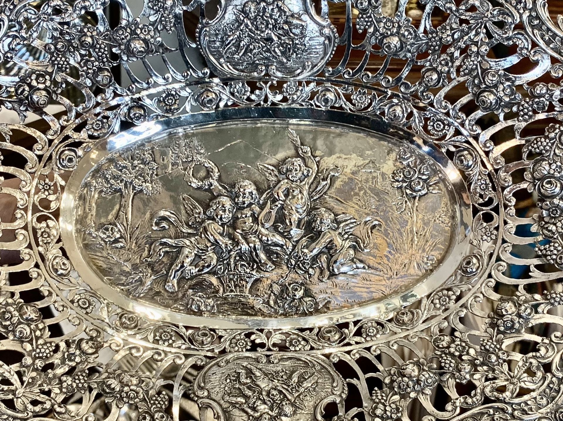 Ornate silver filigree tray with an oval center medallion and intricate floral pattern
