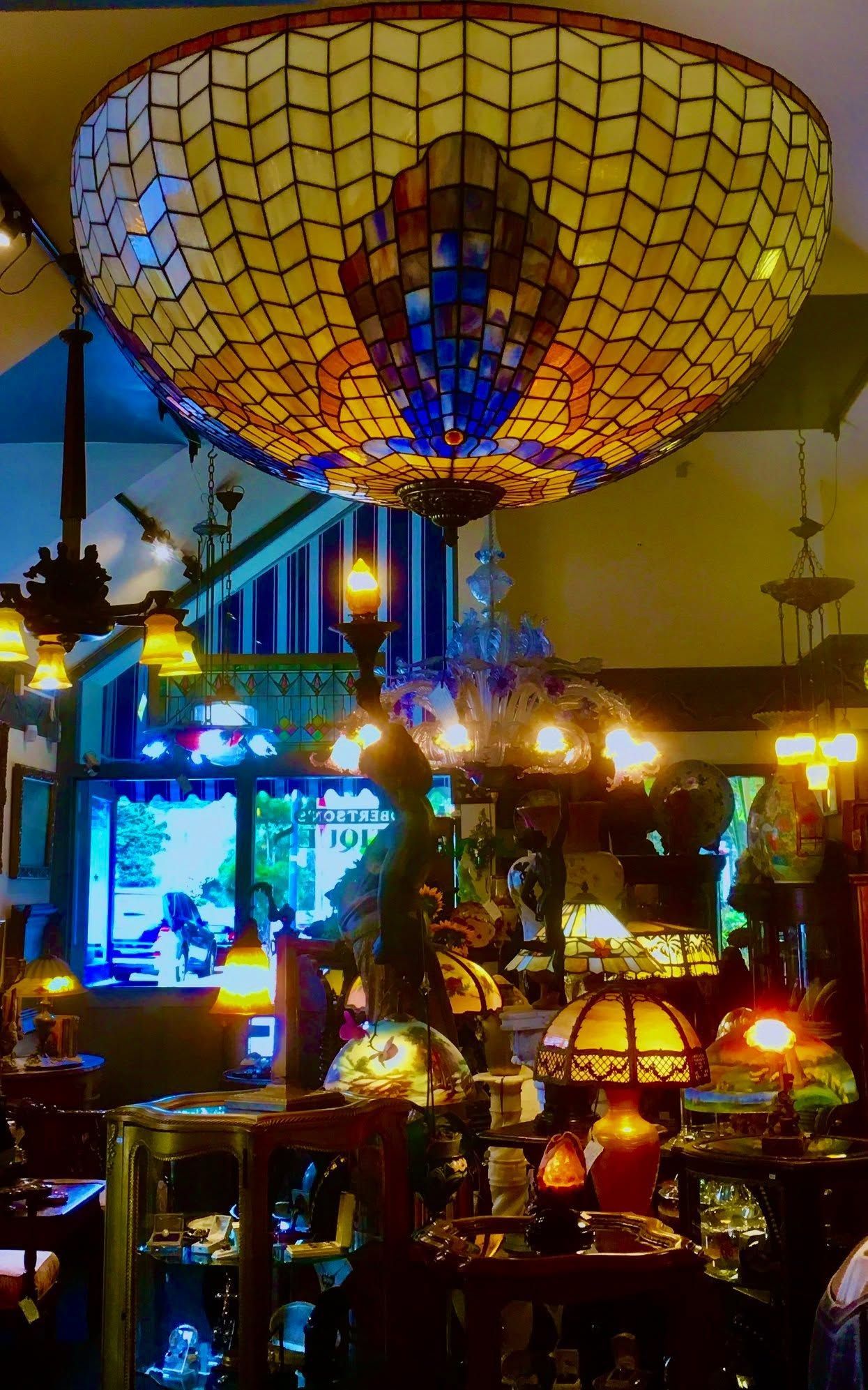 Colorful hanging lamps and lanterns glowing in a warmly lit decorative market or shop interior
