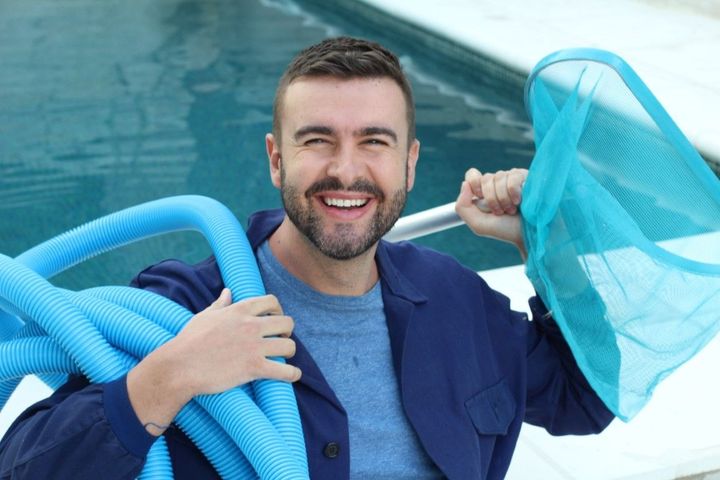 glasses and a pitcher by a clean pool