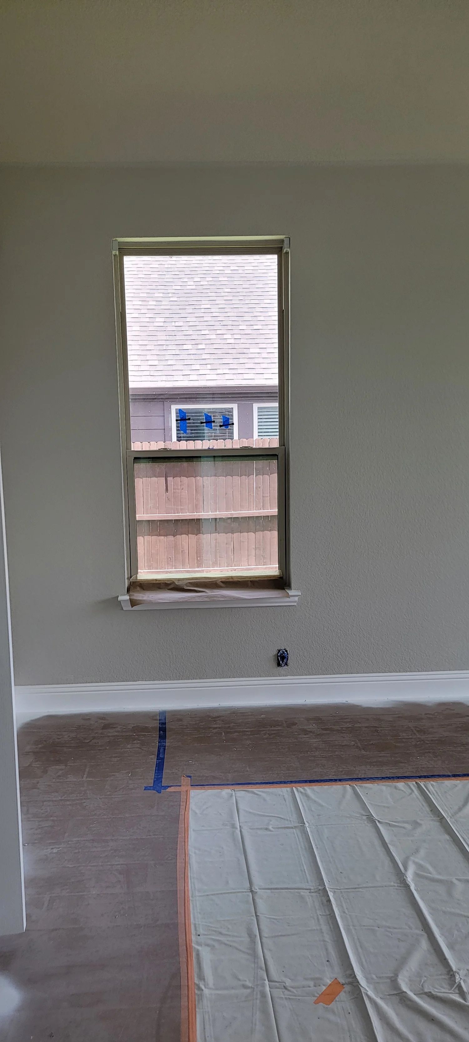Interior view of a room with a window. Construction in progress, textured wall.
