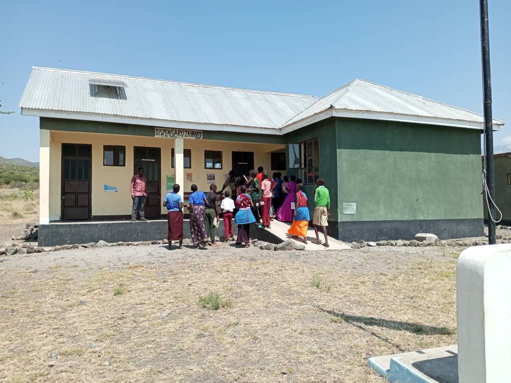 A group of Makat village students entering a green and white school house