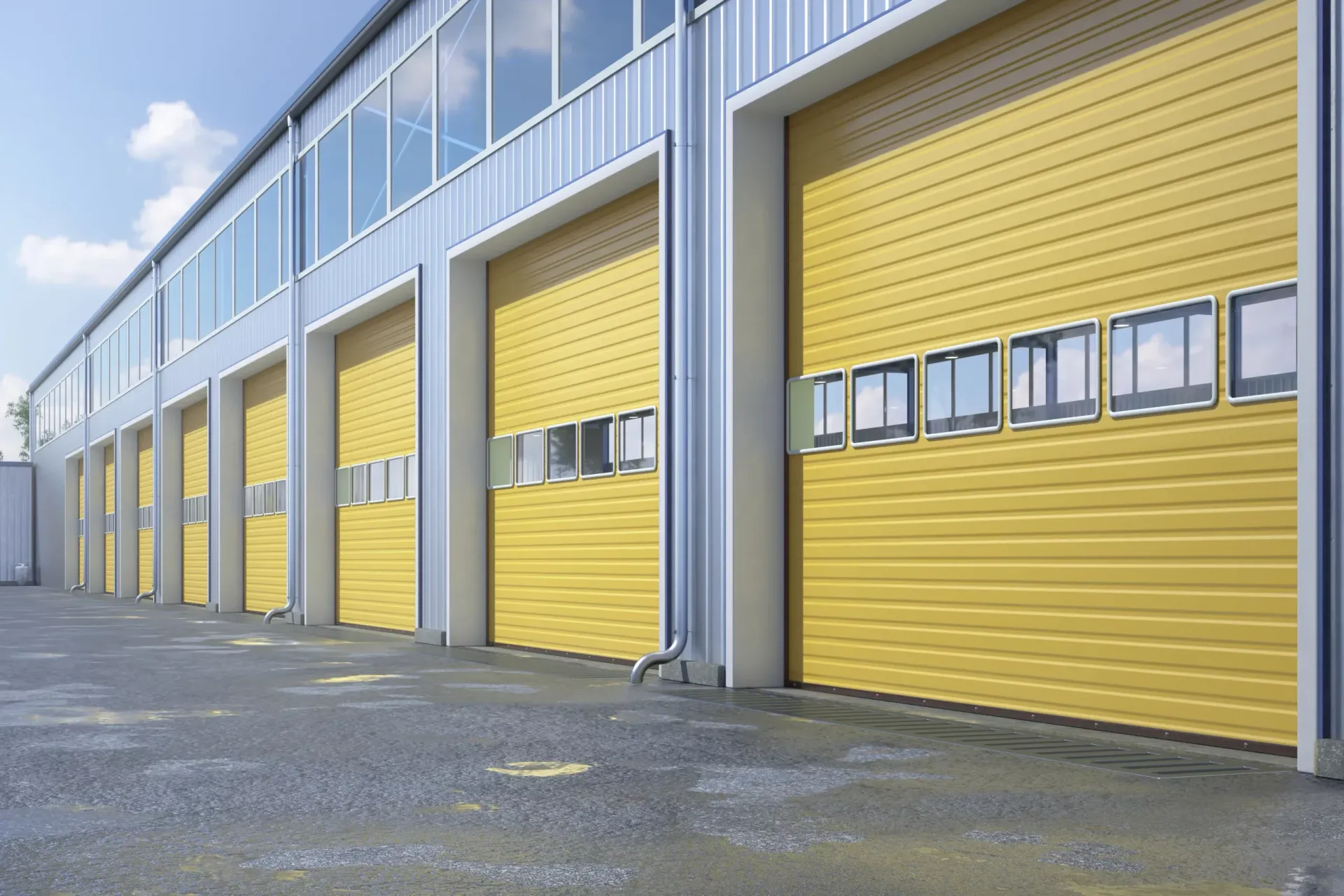 Row of industrial garage doors with bright yellow shutters on a warehouse building
